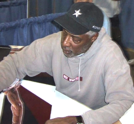 Julius (Dr.J) Erving signing the sports painting of him done by Sports Artist Stephen Marotta